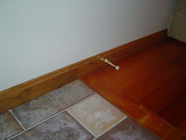 Transitioning baseboard trim that have finished floors with two different heights.