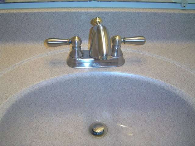 Installing a brushed nickle bathroom faucet is an inexpensive bathroom remodeling idea.