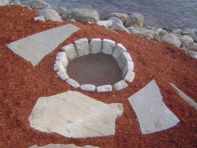 Building a fire pit with granite cobblestones.