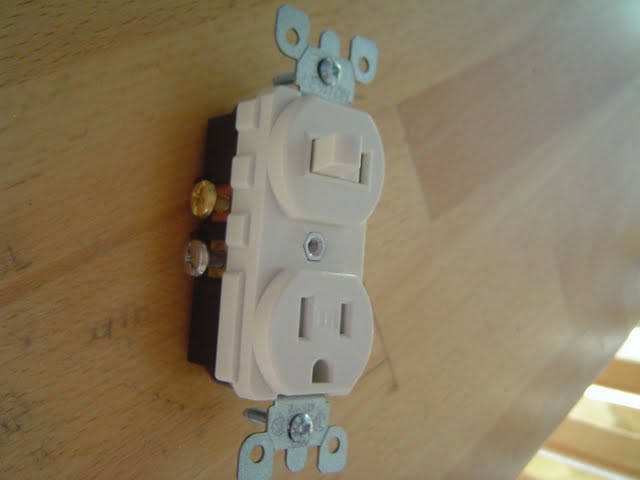 Switch outlet combo with brass and silver screws shown.