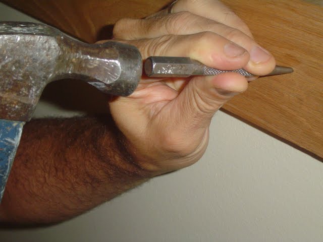 Using a nail set.