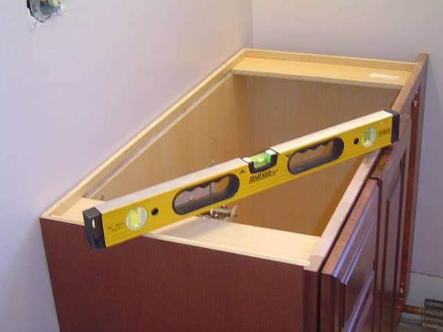 Bathroom Vanity Install - Use a level to make sure the bathroom vanity is level back to front, and side to side.