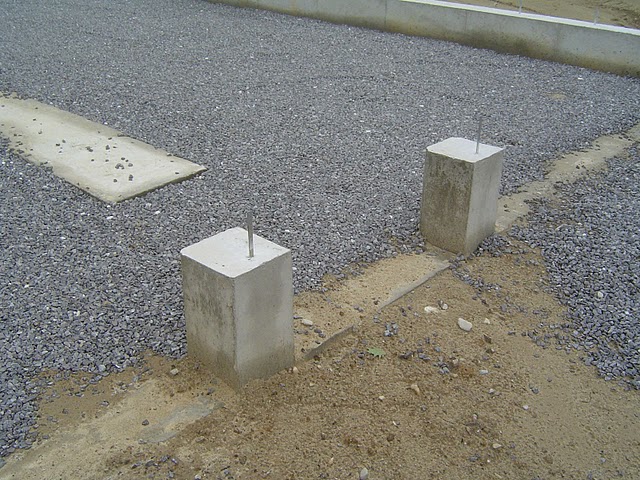 Foundation walls resting on concrete foundation footings. Also there is a footing strip for Lally columns.