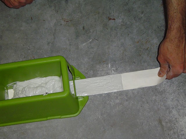 Pull the drywall tape out and upwards from the TapeBuddy.