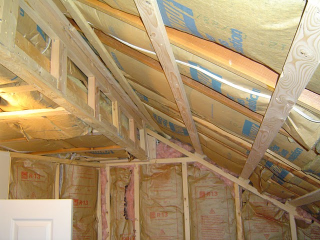 In this attic bedroom remodeling project strapping is installed on the ceiling to support drywall.