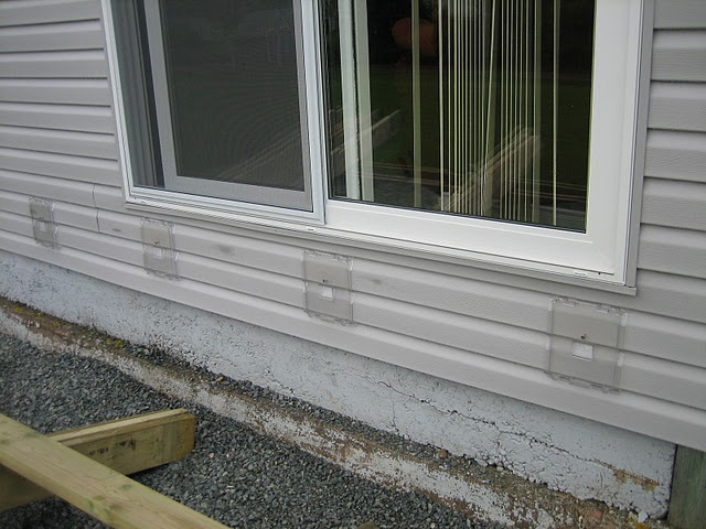 Siding Saver Mounting Brackets screwed to house siding.
