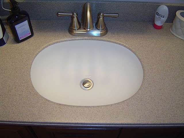 A Corian sink bowl is undermounted to the Solieque vanity countertop